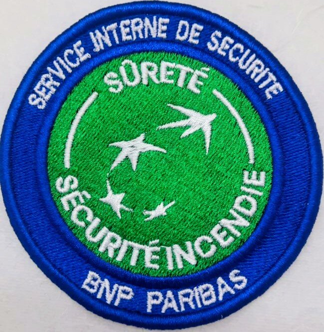 Custom embroidered badge for security service, made by Alias Broderie